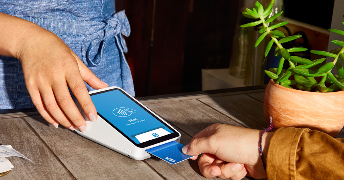 A customer dipping a card into a Square Terminal at a counter